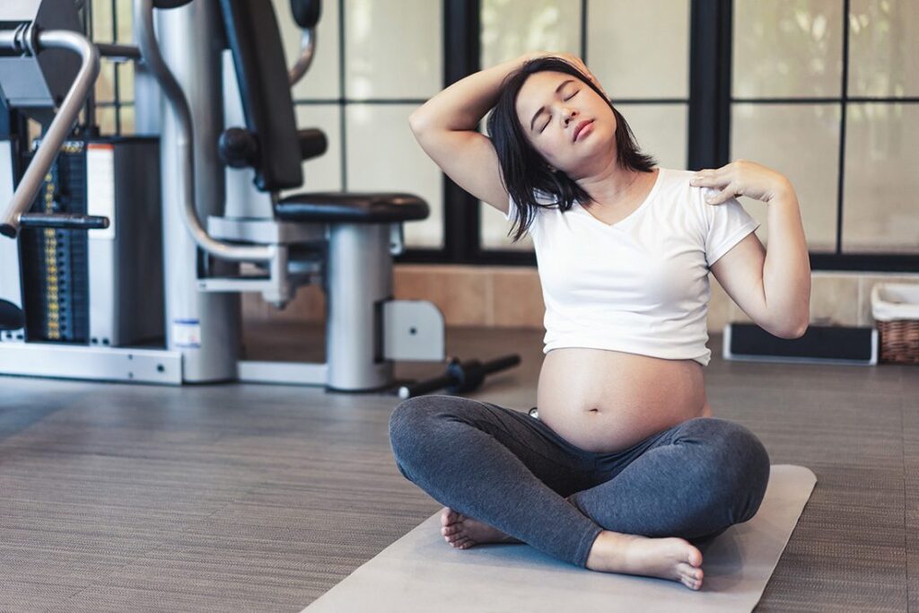 Active Pregnant Woman Exercise In Fitness Center